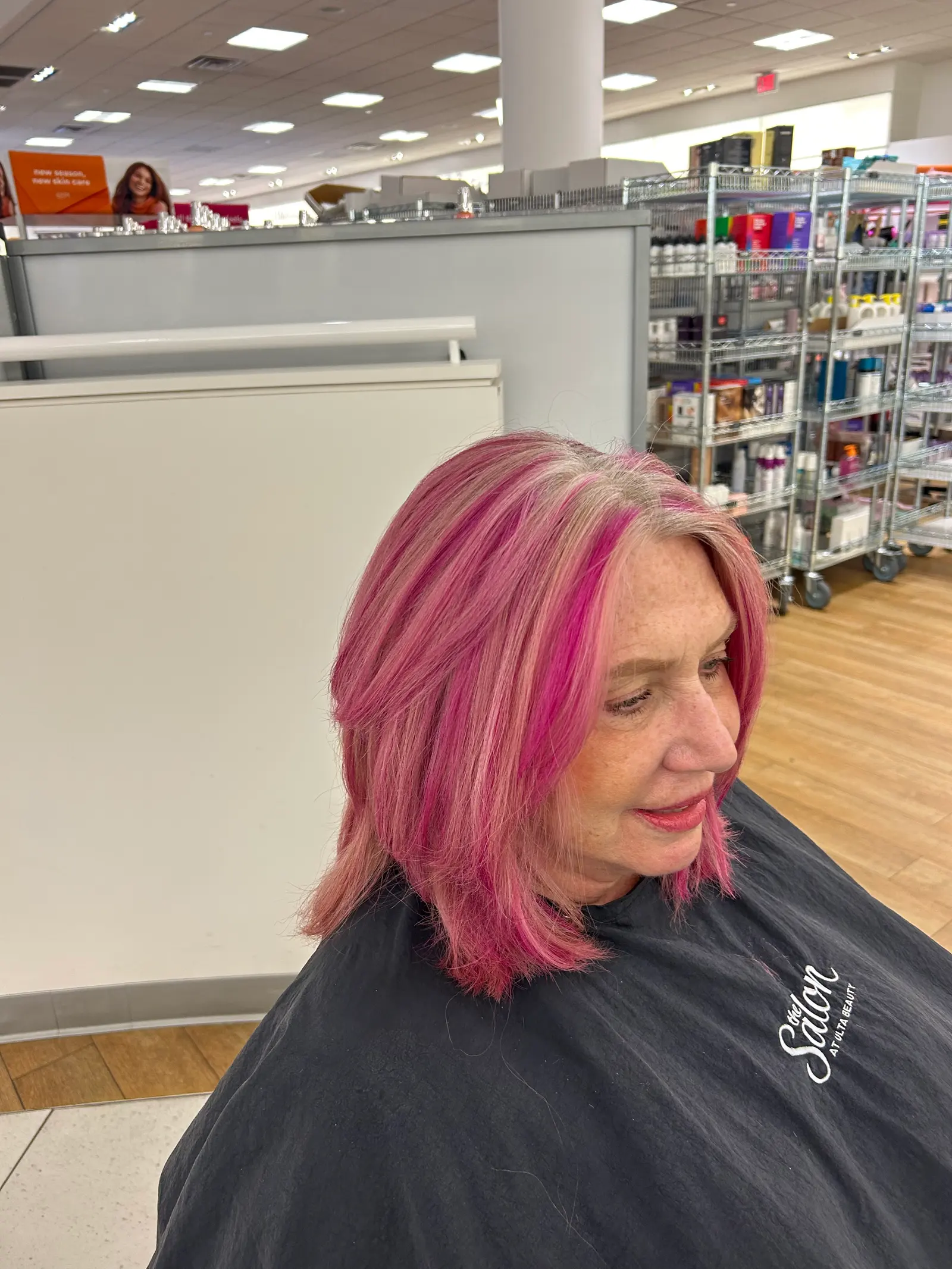 Blended pink and blonde color on a shoulder-length cut